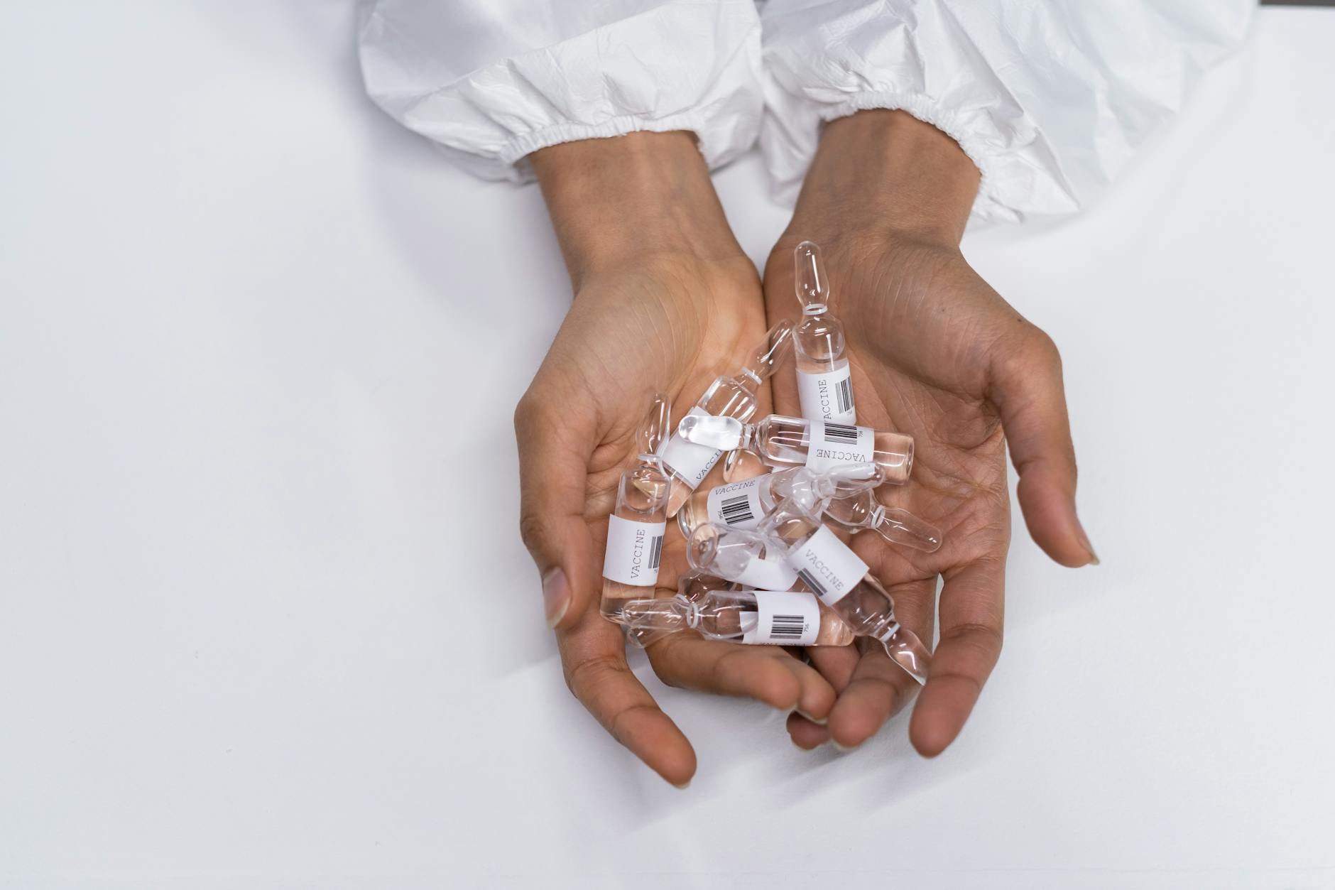 Vaccine Vials on Womans Hands