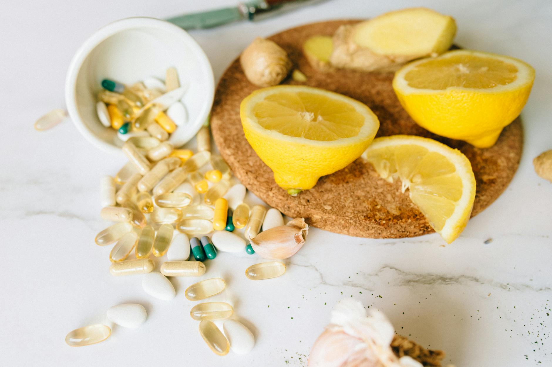 Capsules and Tablets and Sliced Lemon on a Corkboard