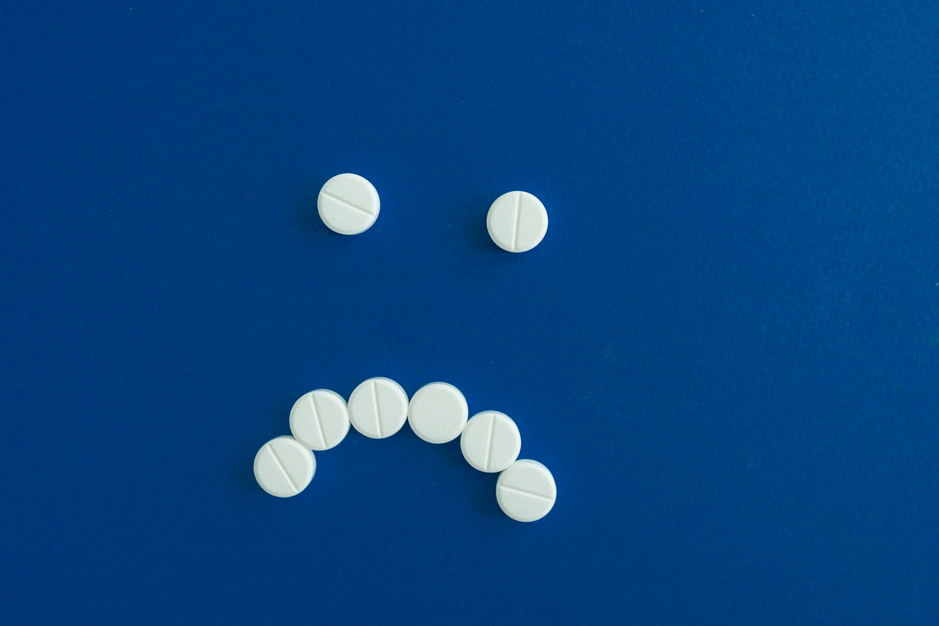 Medicine Tablets on Blue Surface