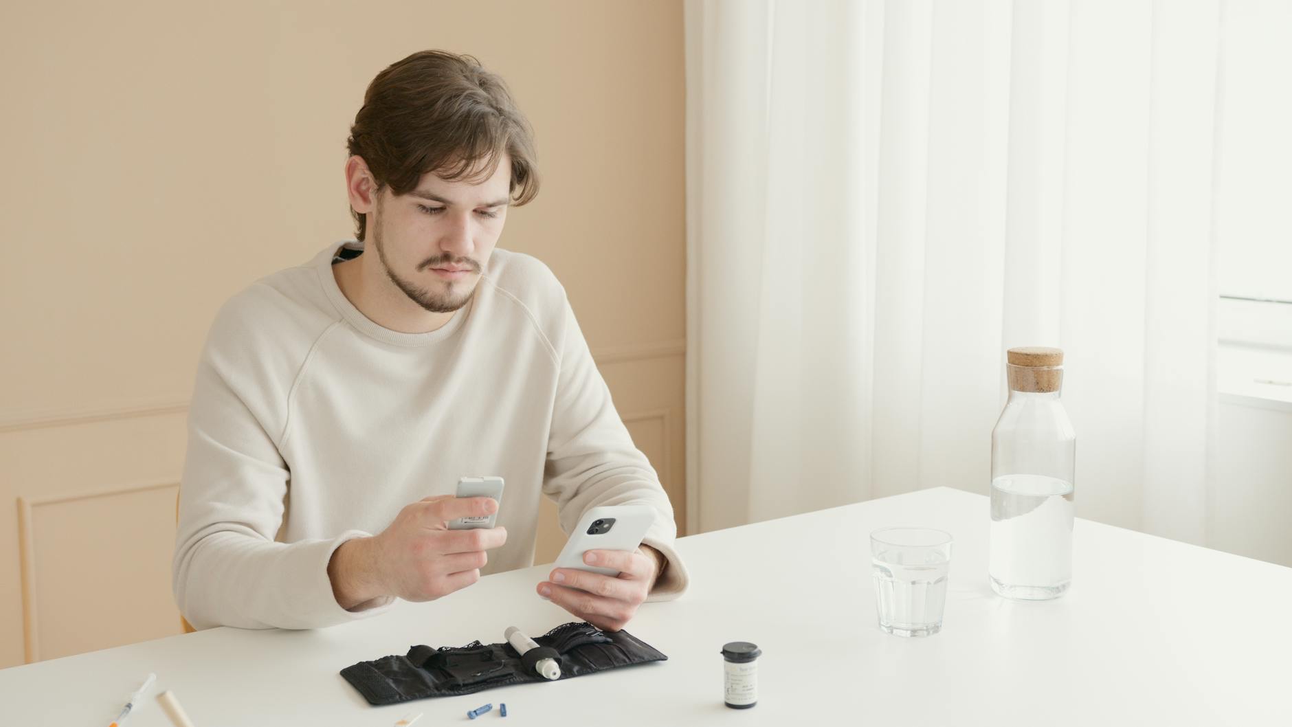 A young man checks his blood glucose level using a glucometer at home.